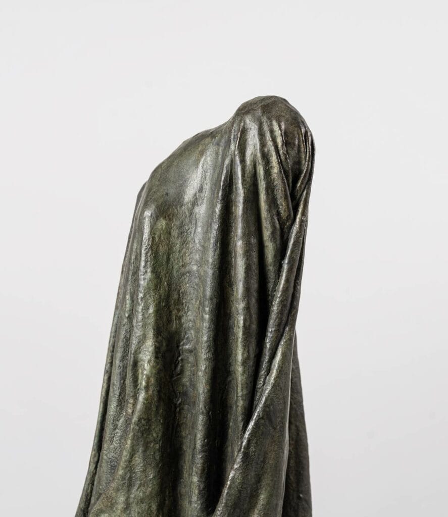 Cette sculpture en bronze intitulée "Ombre Voilée I" par Guy Le Perse trouve son inspiration dans la "Divine Comédie" de Dante, et représente un hypocrite condamné dans le huitième cercle de l'Enfer.