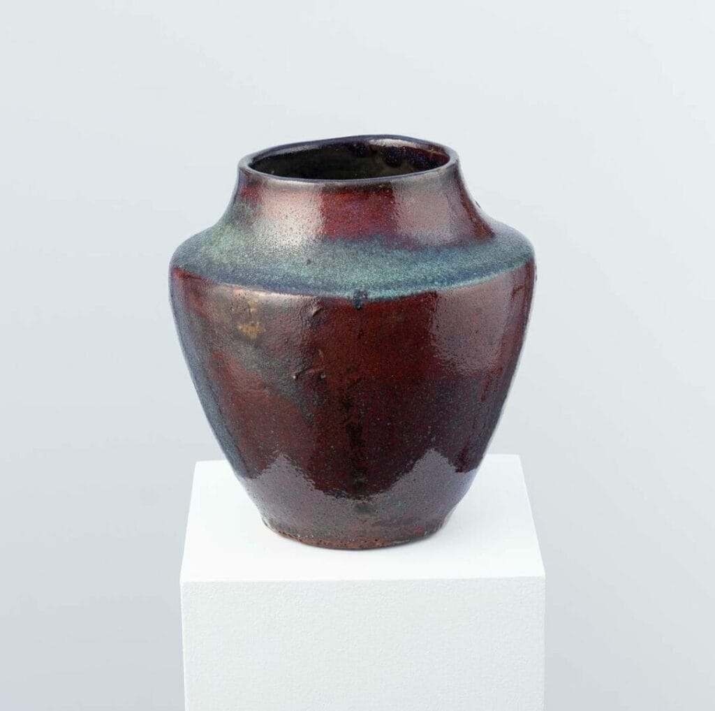Designed by Eugène Lion, a ceramist of the Carriès school, this red-glazed stoneware vase reveals Japonism and Wabi-Sabi, produced in Puisaye.