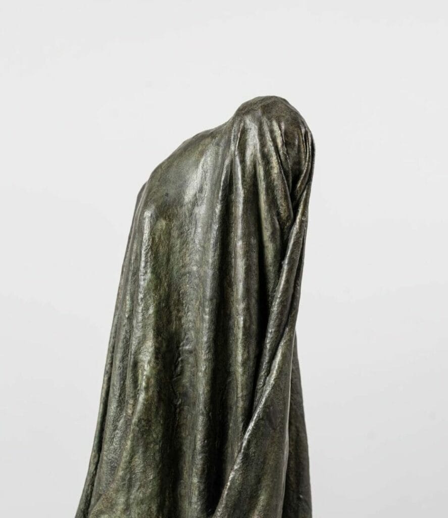 This bronze sculpture entitled "Veiled Shadow I" by Guy Le Perse finds its inspiration in Dante's "Divine Comedy" and represents a hypocrite condemned in the eighth circle of Hell.